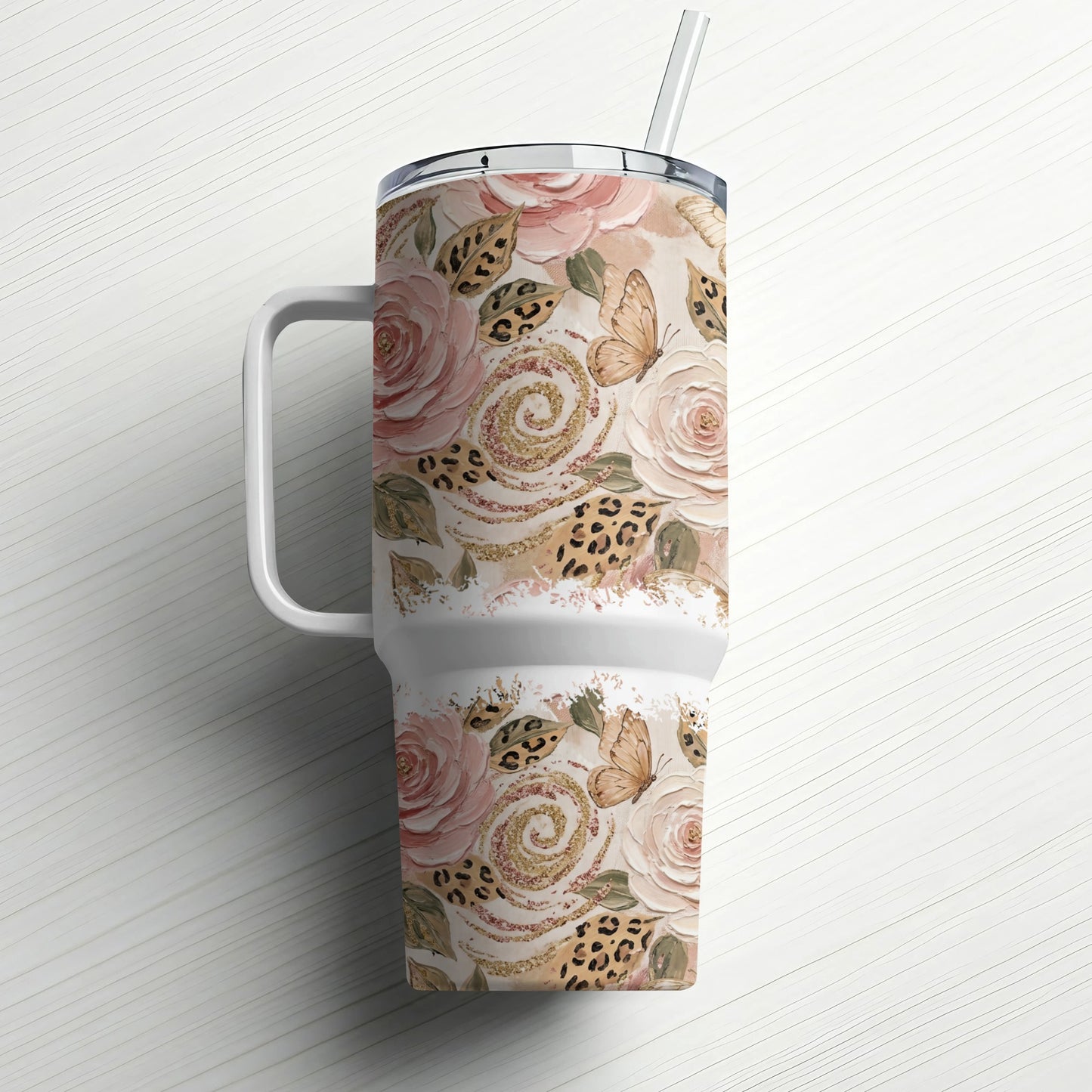 Tumbler with floral and butterfly pattern, white handle, and straw.
