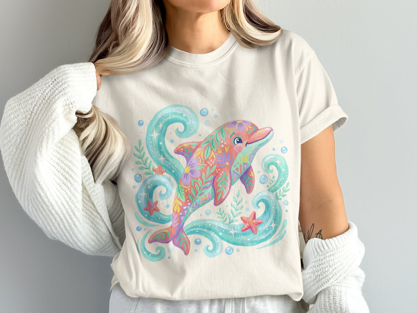 Cream t-shirt with a colorful floral dolphin and bubbles design.