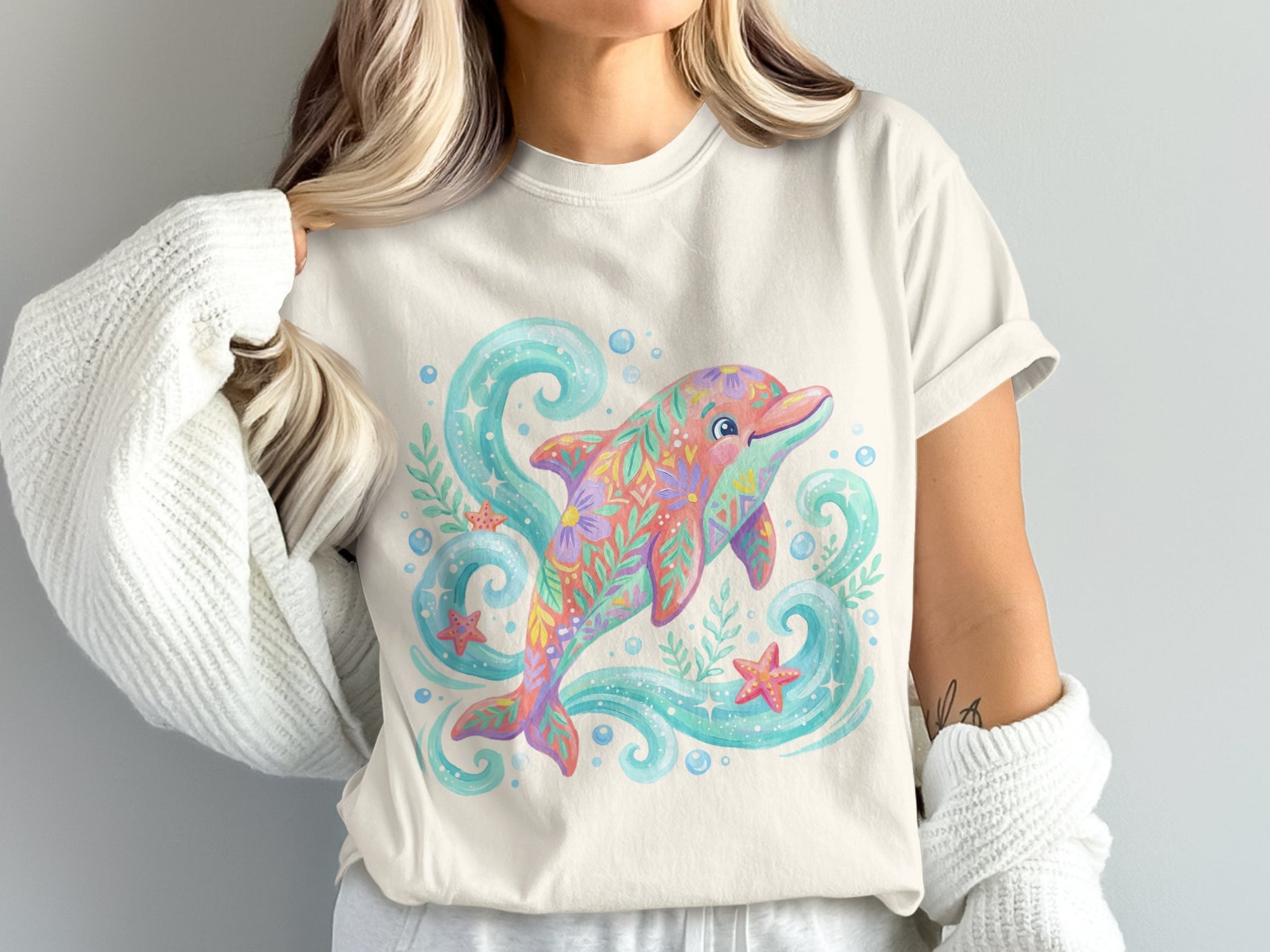 Cream t-shirt with a colorful floral dolphin and bubbles design.