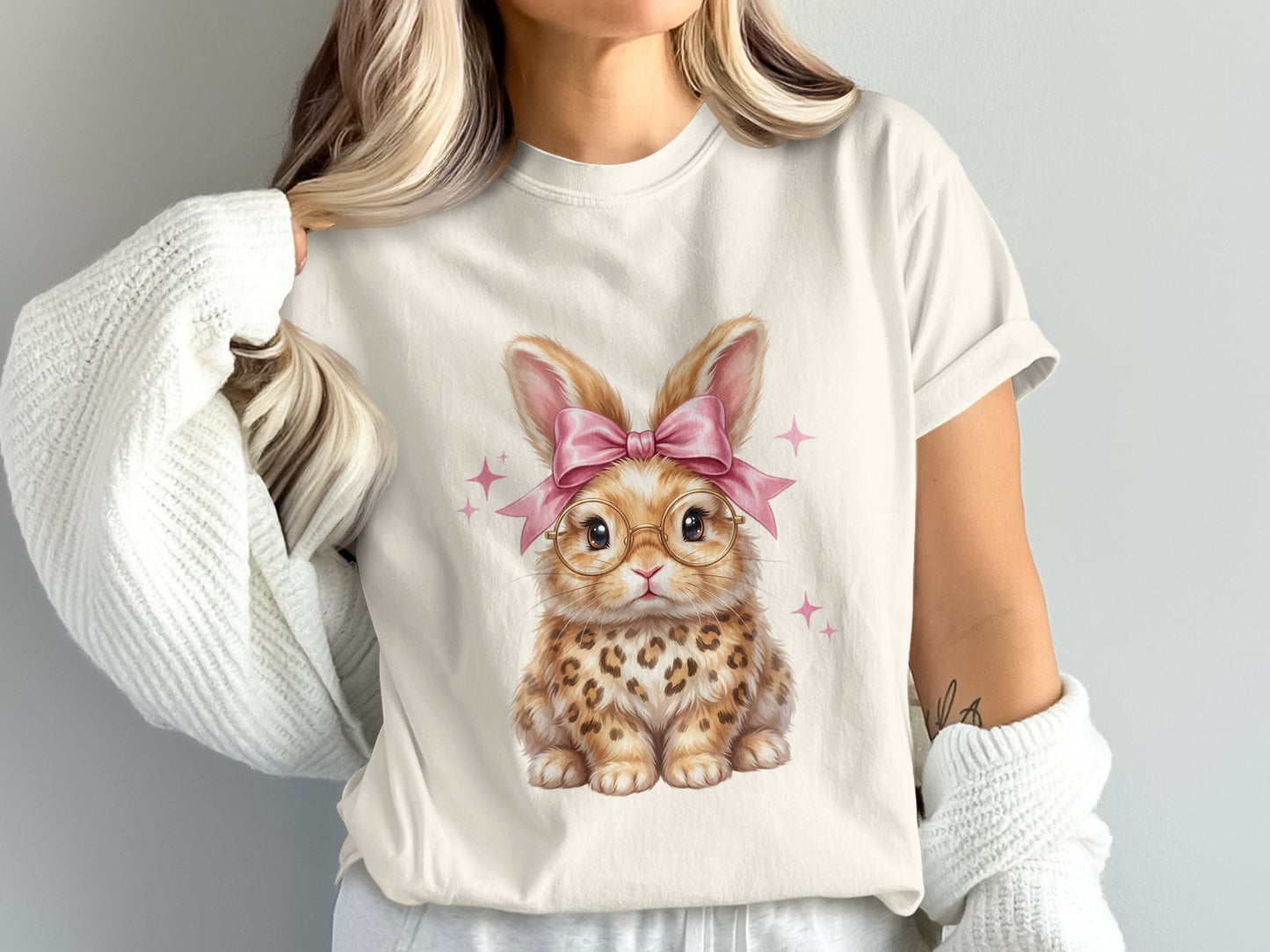 Cute cartoon bunny with pink bow and glasses, sitting with pink stars.