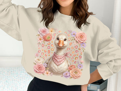 Cream sweatshirt with a cute goose wearing a pink bandana surrounded by flowers.
