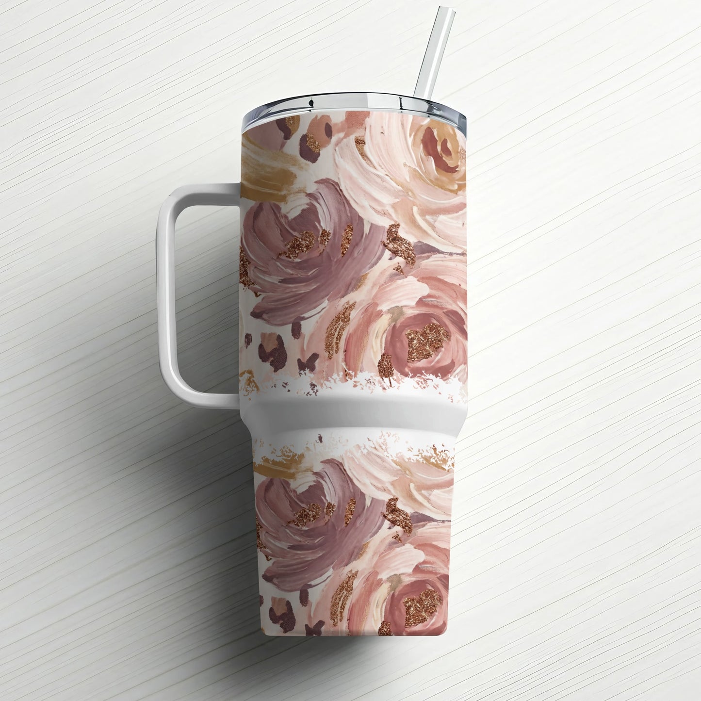 White tumbler with pink and brown floral watercolor pattern and straw.