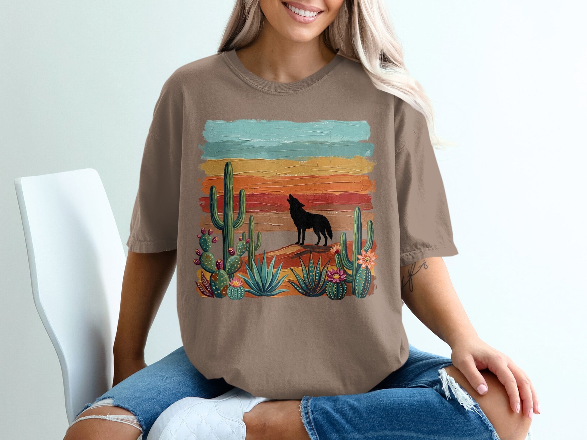 Wolf howling at sunset with cacti and desert landscape graphic on brown t-shirt.