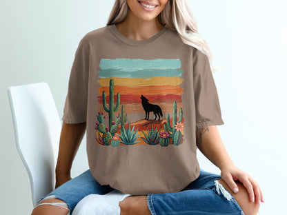 Wolf howling at sunset with cacti and desert landscape graphic on brown t-shirt.