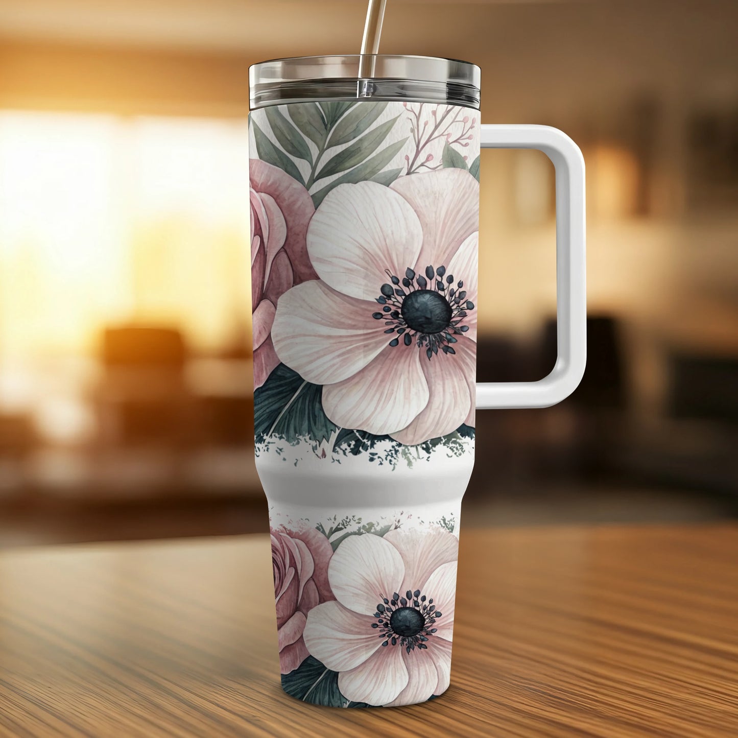 White tumbler with pink floral design and handle.