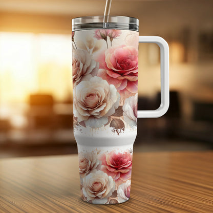 Pink and white roses adorn a tall travel tumbler with a white handle and straw.