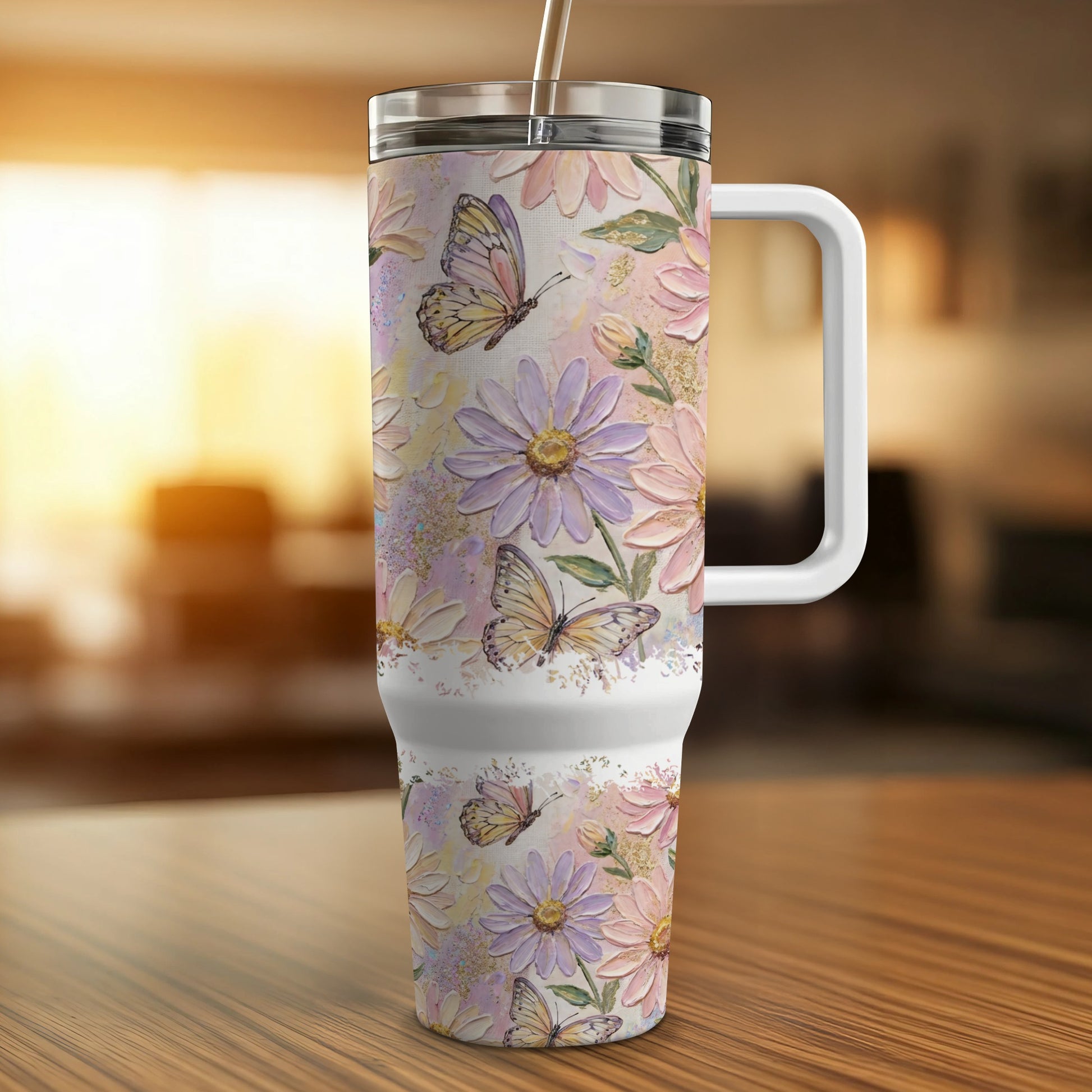 Floral patterned tumbler with butterflies and handle on a wooden surface.