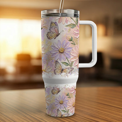 Floral patterned tumbler with butterflies and handle on a wooden surface.