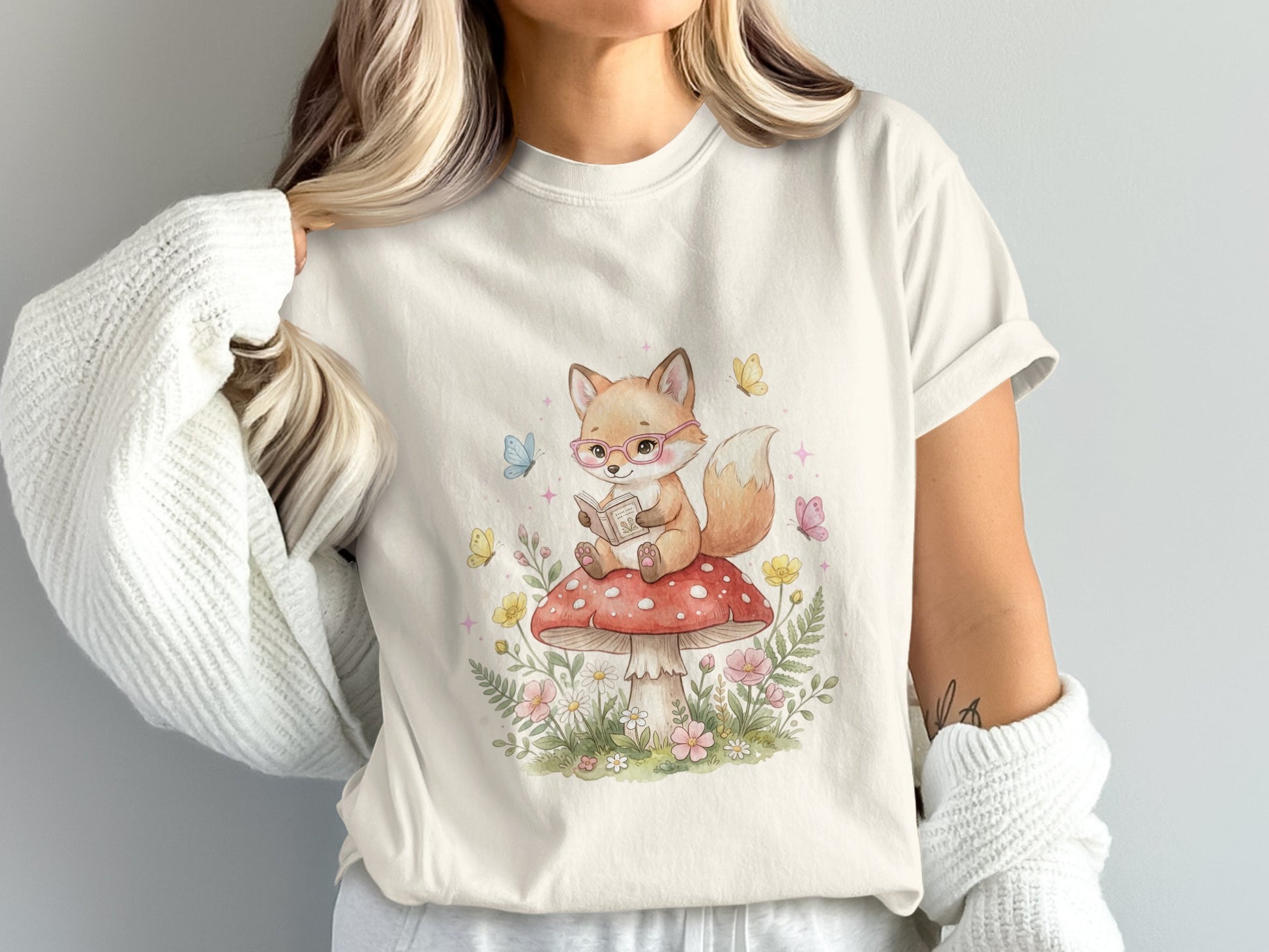 Fox wearing glasses reading on a mushroom with butterflies and flowers.