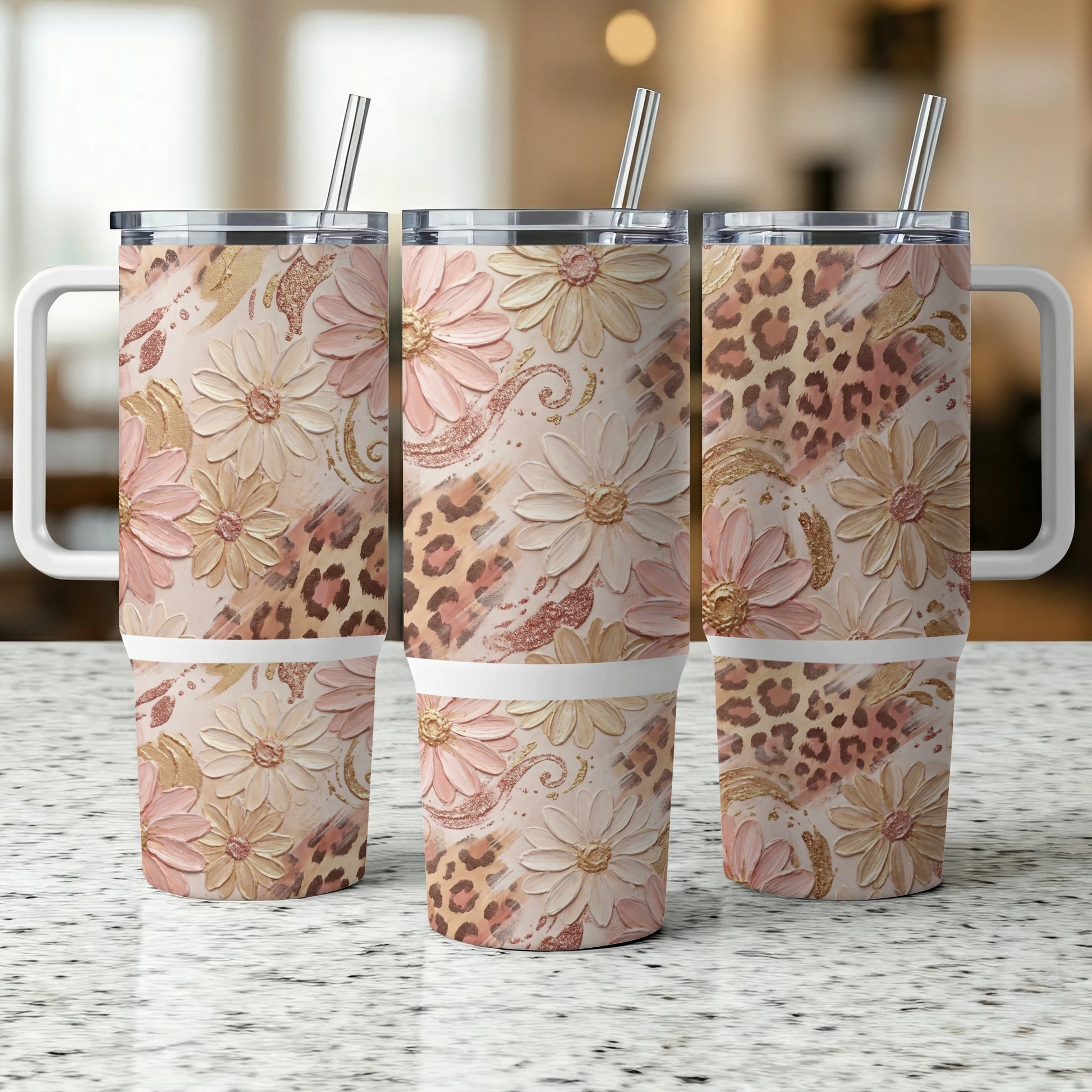 Three floral and leopard print tumblers with handles and straws.