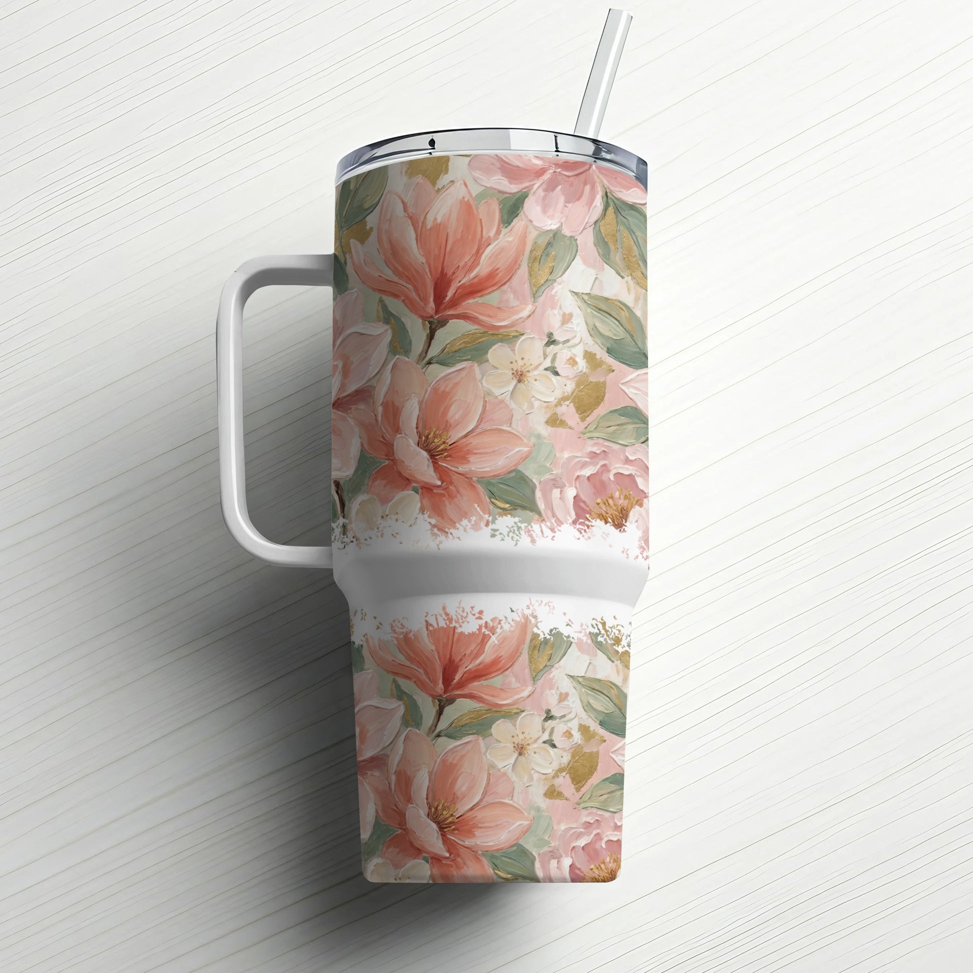 Tall tumbler with handle and straw, featuring a floral pattern of pink magnolias and green leaves.