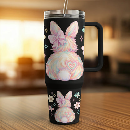 Black tumbler with pastel rainbow bunny, flowers, and butterflies.