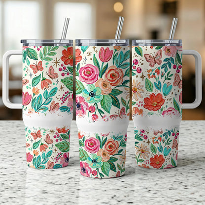 Three tumblers with floral and butterfly designs on a speckled countertop.