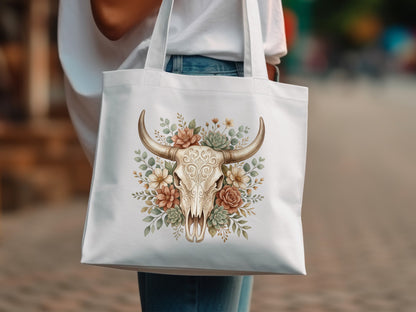 White tote bag with a bull skull adorned with flowers and succulents.