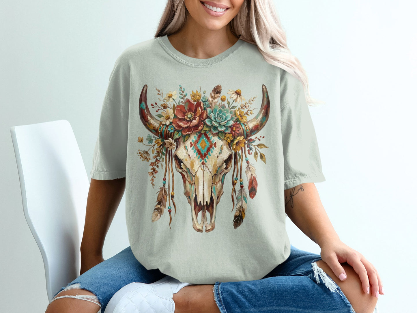 Light gray t-shirt with a cow skull and floral headdress graphic.