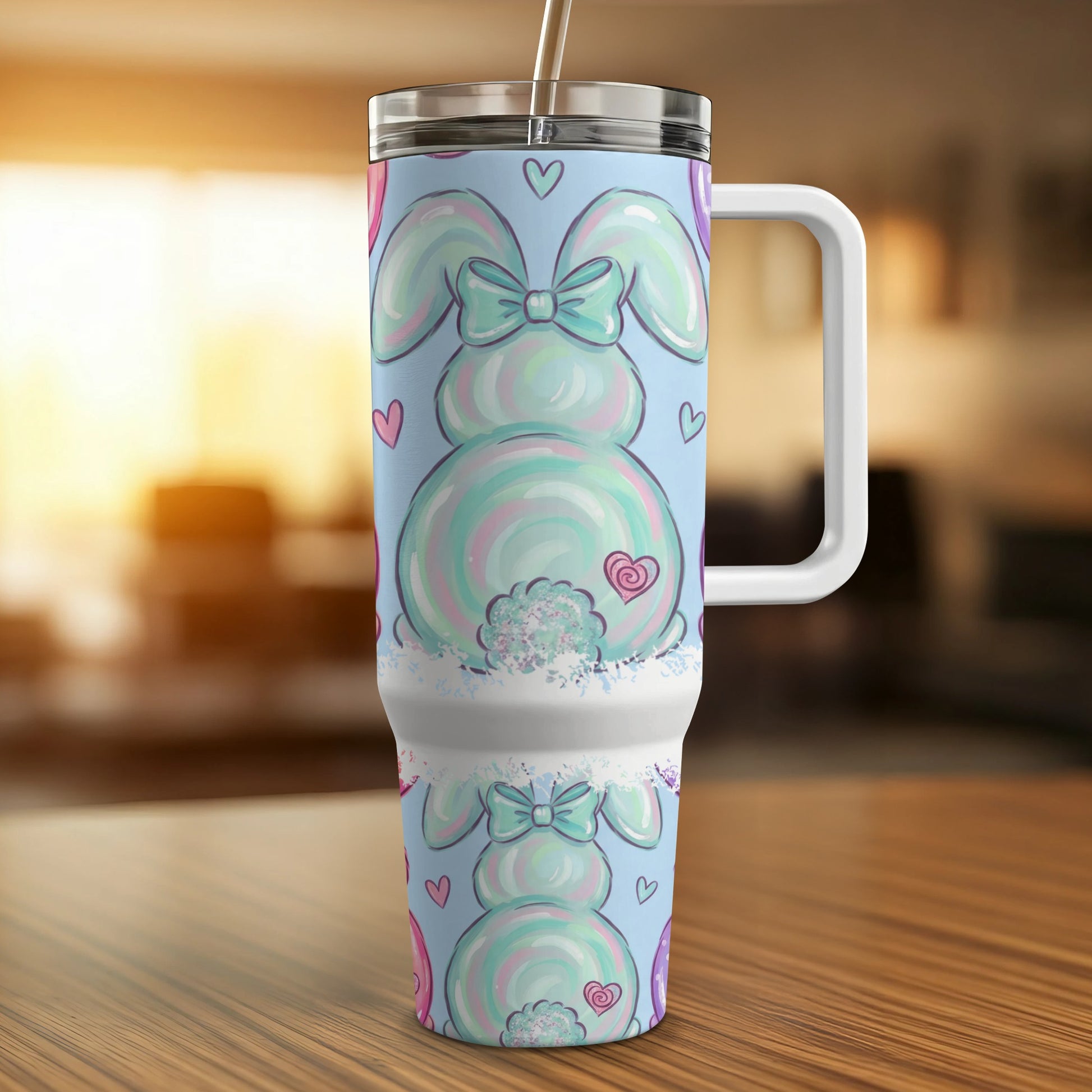 Pastel bunny tumbler with hearts and bow, on a wooden table.
