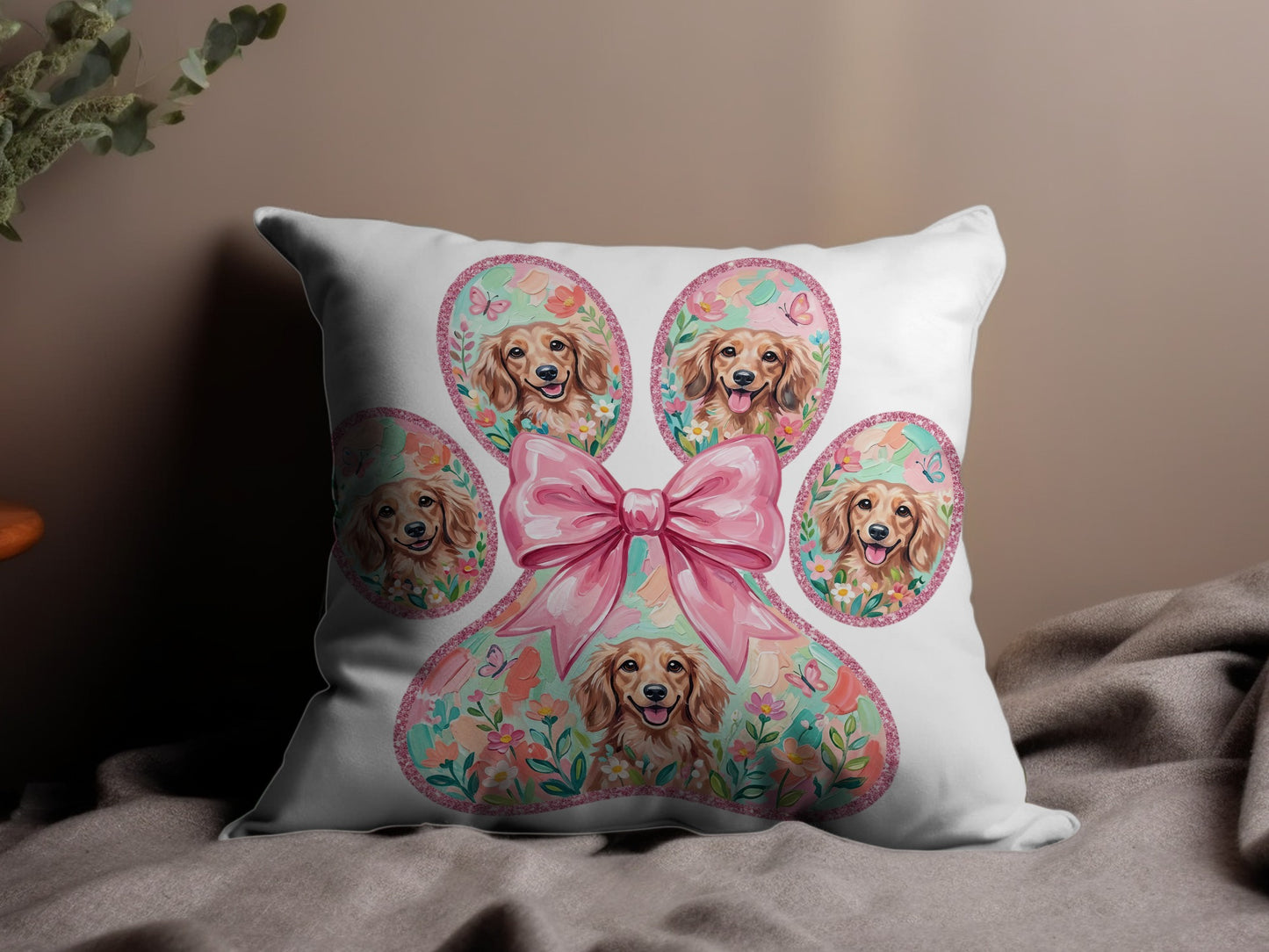 Paw print pillow with golden retriever faces, pink bow, and floral accents.