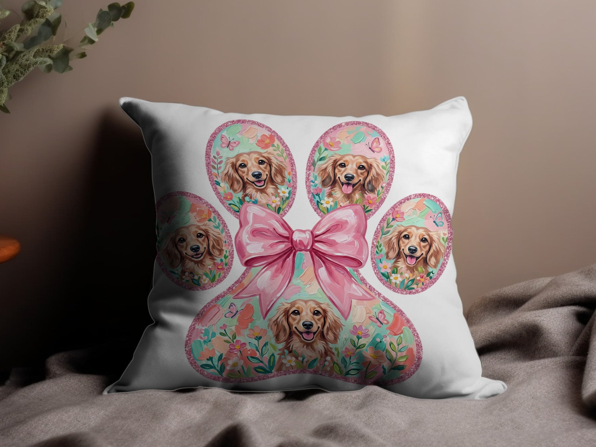 Paw print pillow with golden retriever faces, pink bow, and floral accents.