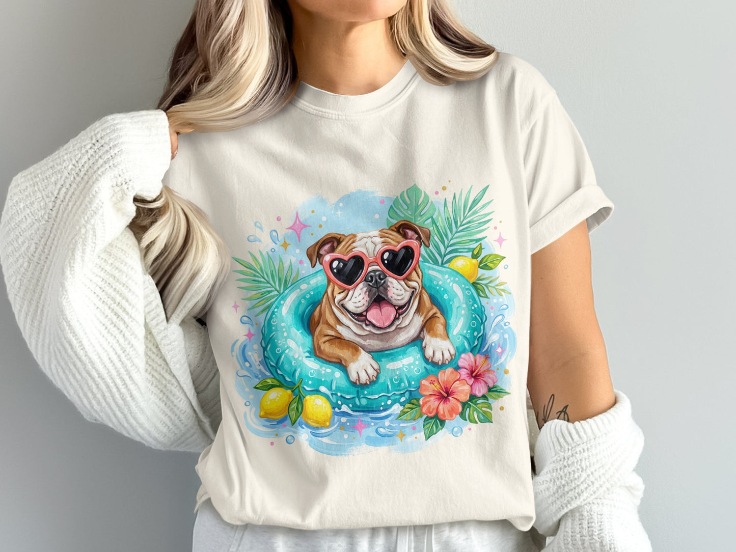 Bulldog in heart sunglasses floats in a pool with lemons and tropical leaves.