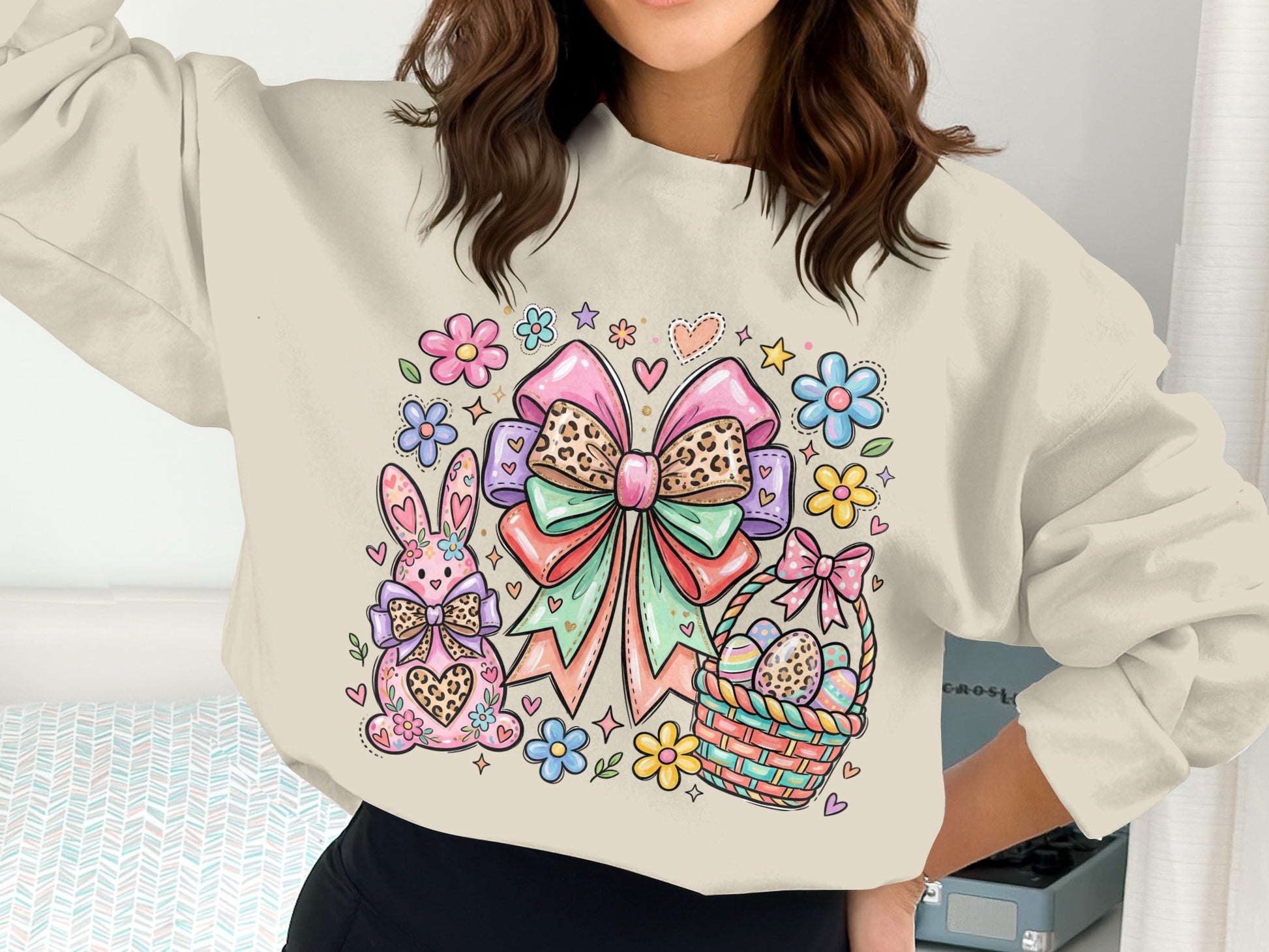 Cream sweatshirt with Easter bunny, decorated eggs, flowers, and large bow.