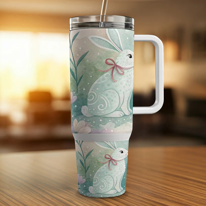White Easter bunny with pink ribbon on a floral patterned tumbler.