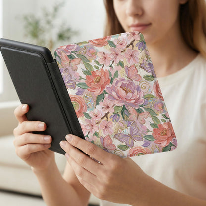 Woman holding a floral patterned e-reader cover with butterflies.