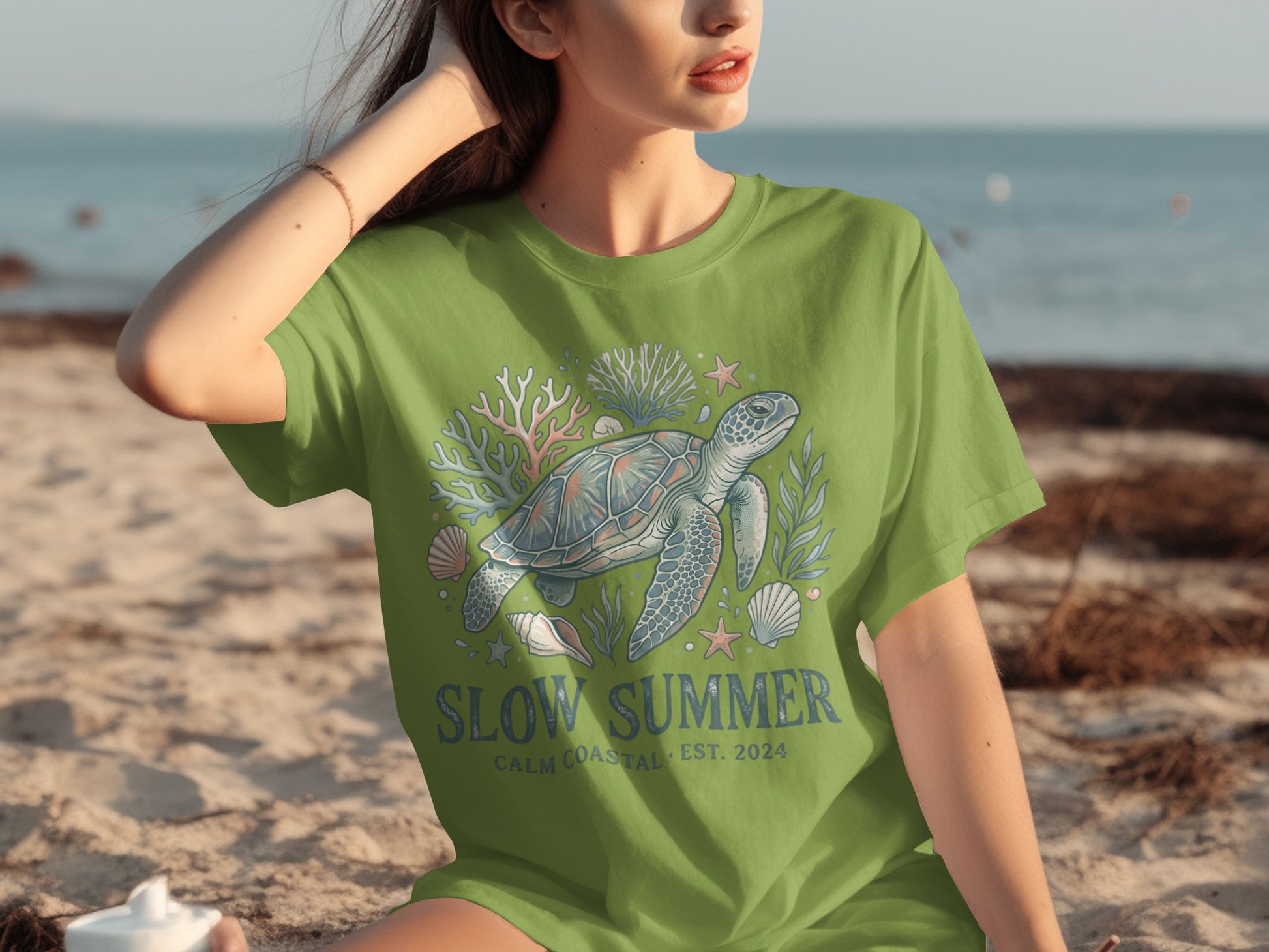 Green t-shirt with sea turtle, coral, and shells graphic and "Slow Summer" text.