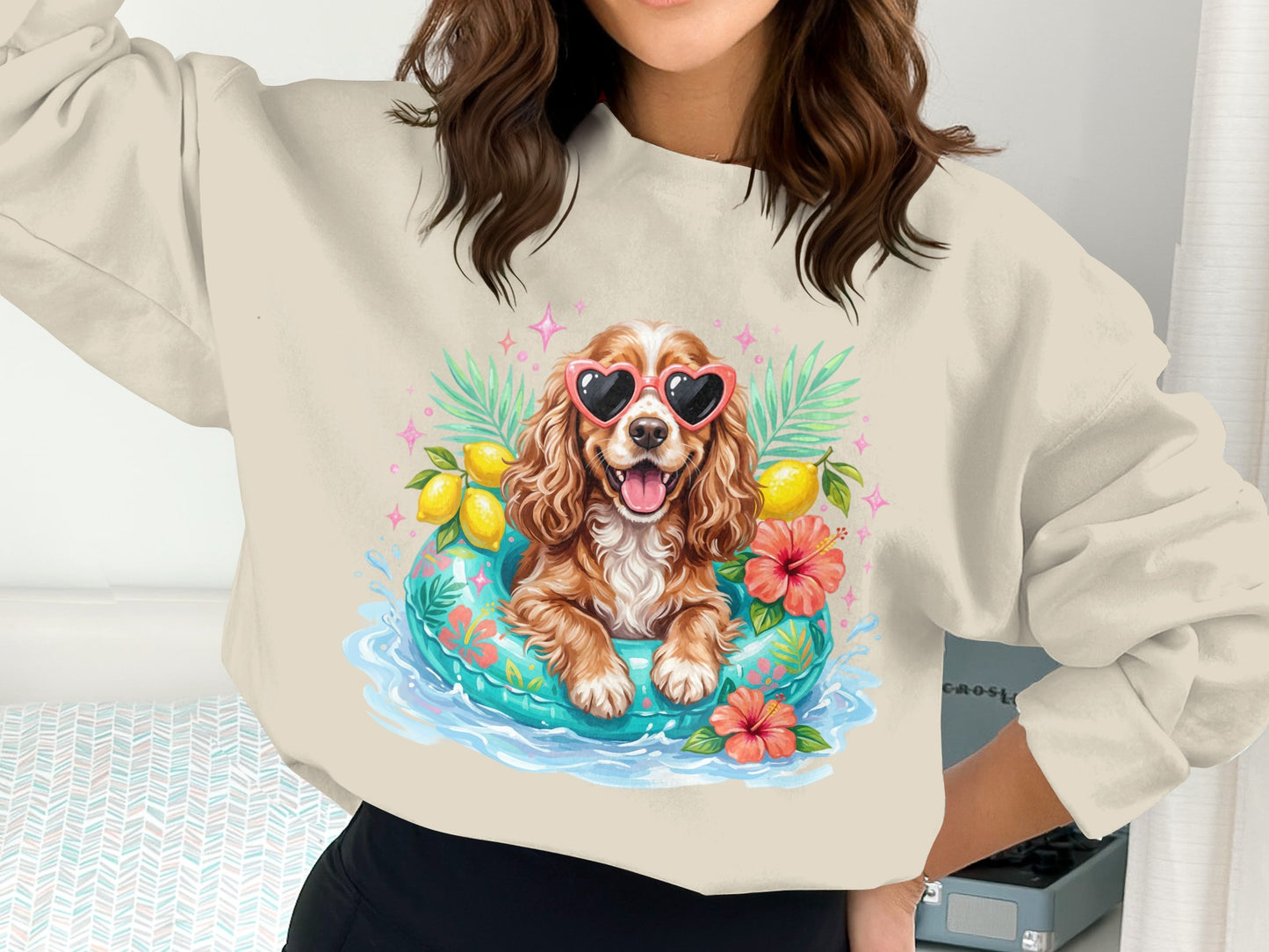 Woman wearing sweatshirt with a cartoon dog in a life raft with hearts.