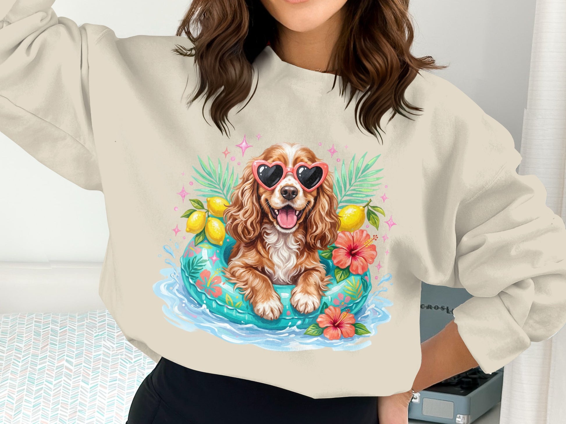 Woman wearing sweatshirt with a cartoon dog in a life raft with hearts.