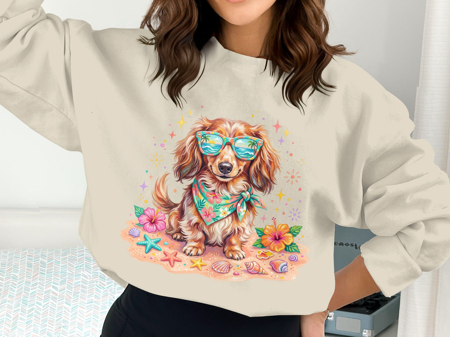 Dachshund wearing sunglasses and bandana on beach with seashells and flowers.