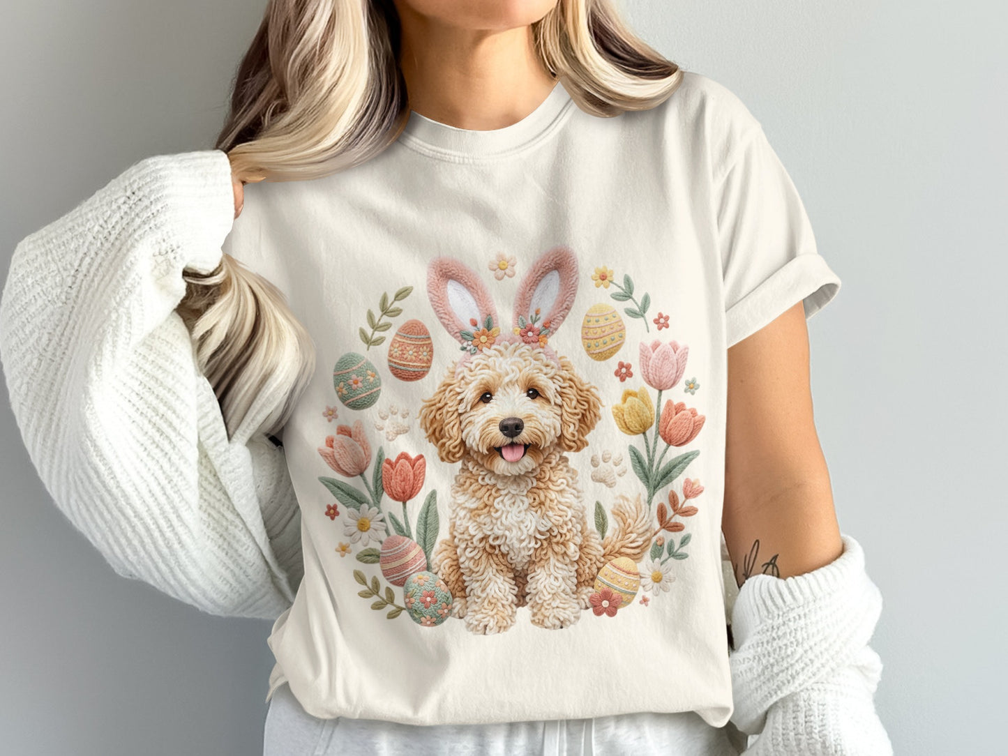 Cream t-shirt with Easter doodle dog wearing bunny ears and floral details.