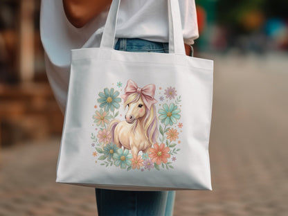 White tote bag with a pastel unicorn and floral design.
