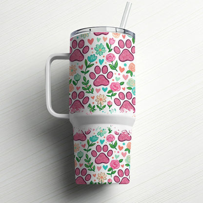 White tumbler with pink paw prints, flowers, and hearts pattern and straw.