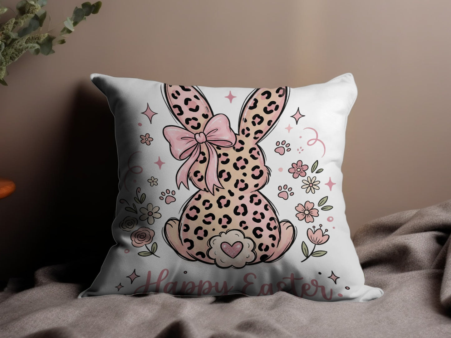 Pillow with pink leopard print bunny, bow, flowers, and "Happy Easter" text.