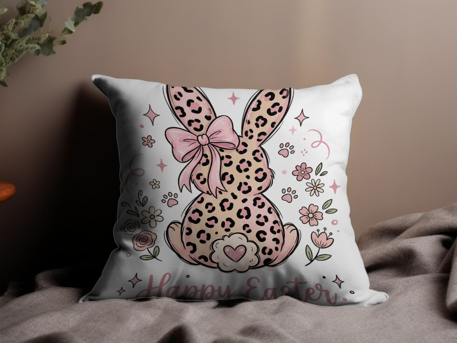 Pillow with pink leopard print bunny, bow, flowers, and "Happy Easter" text.
