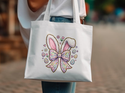 White tote bag with pastel Easter bunny ears, bow, and decorated eggs.