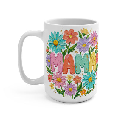 White mug with "MAMA" in colorful letters surrounded by flowers.