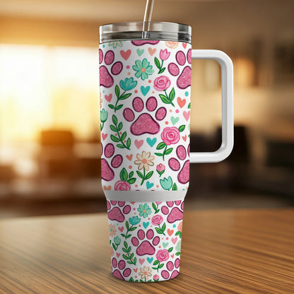 Tumbler with pink paw prints and colorful flowers pattern.