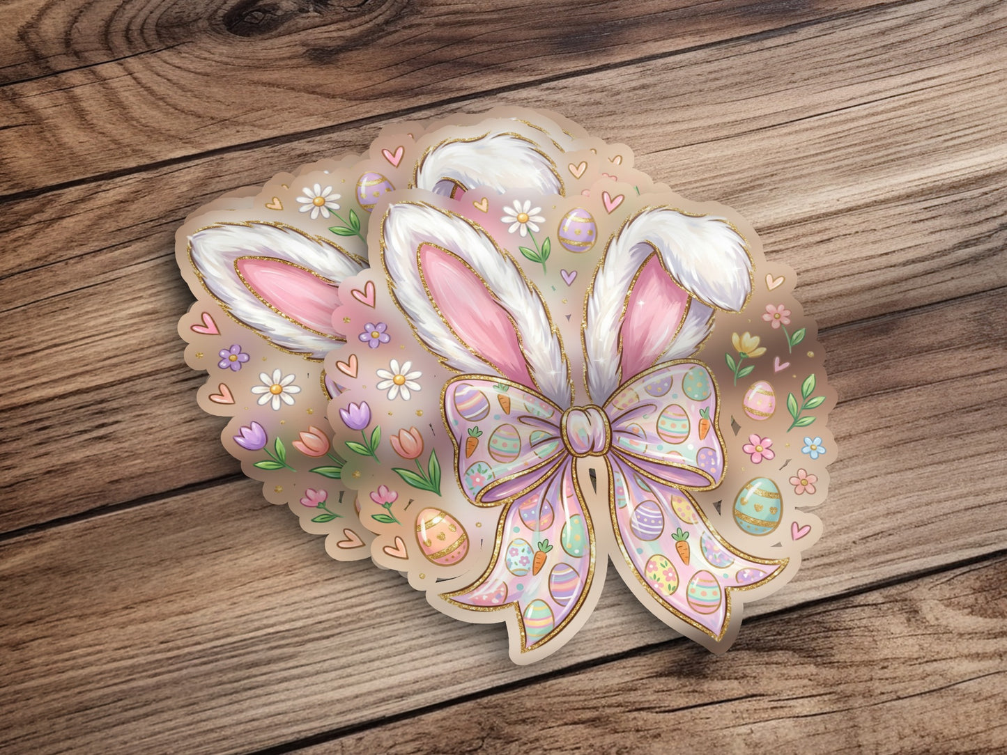 Easter bunny ears sticker with bow, eggs, and flowers on wood.