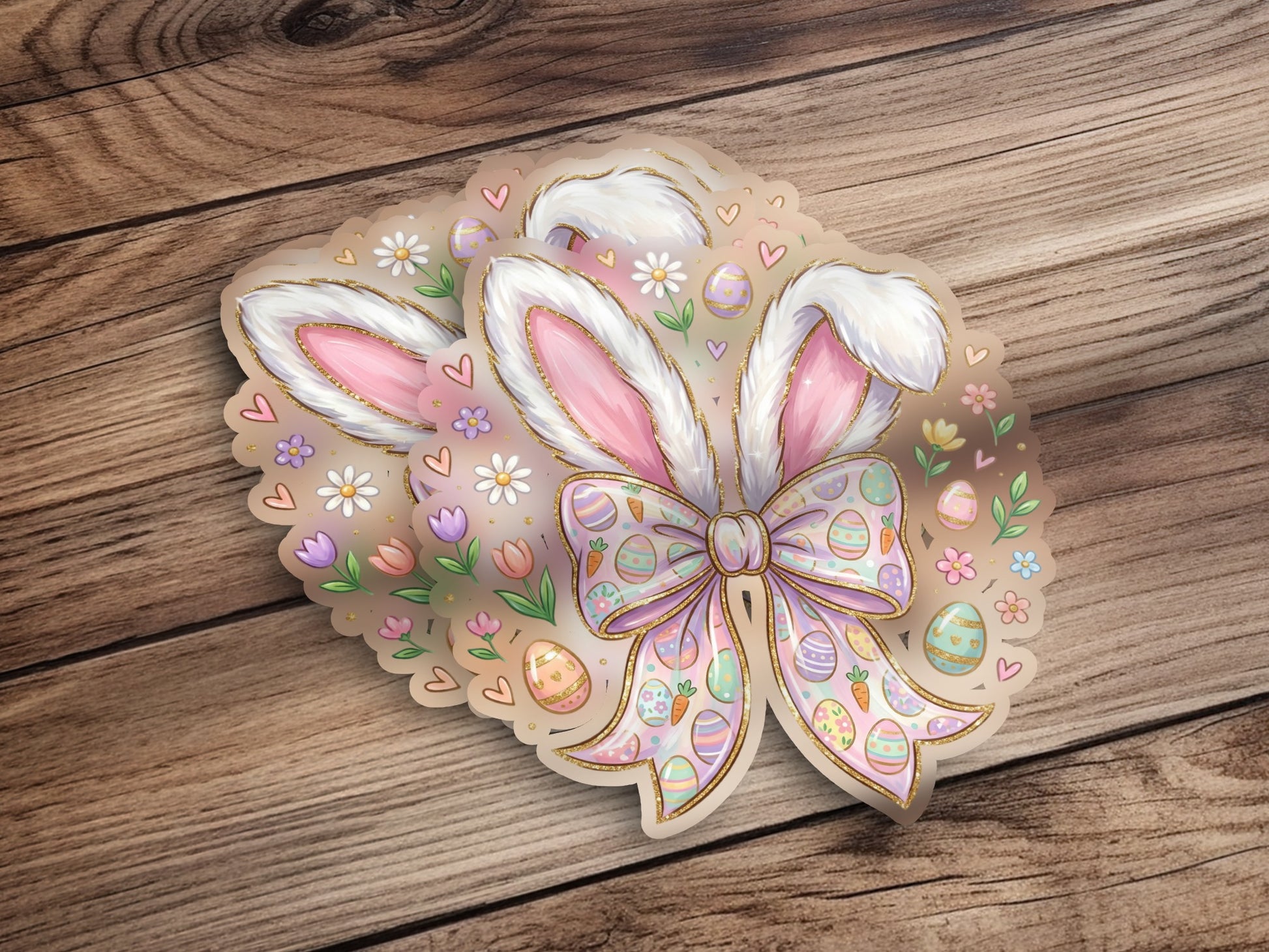 Easter bunny ears sticker with bow, eggs, and flowers on wood.
