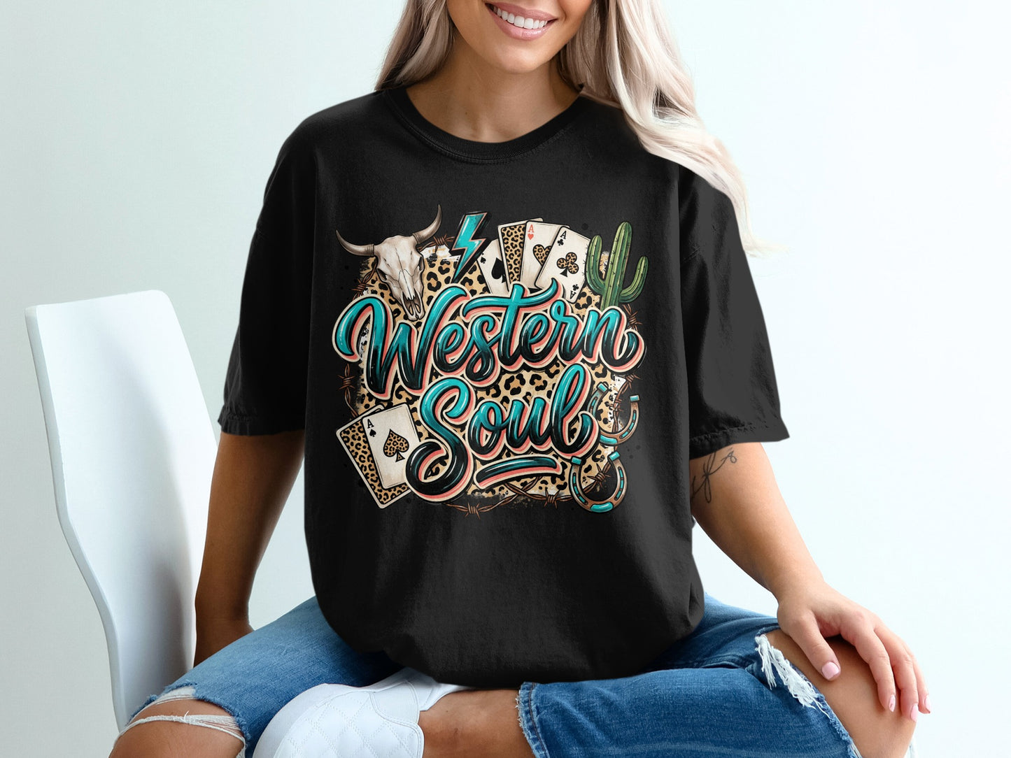 Black t-shirt with "Western Soul" text, playing cards, skull, and cactus graphic.