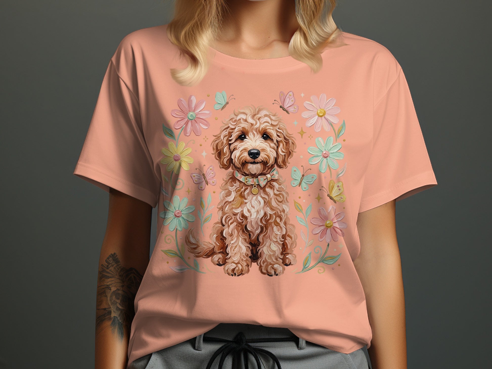 Peach t-shirt with a smiling doodle dog and floral border.
