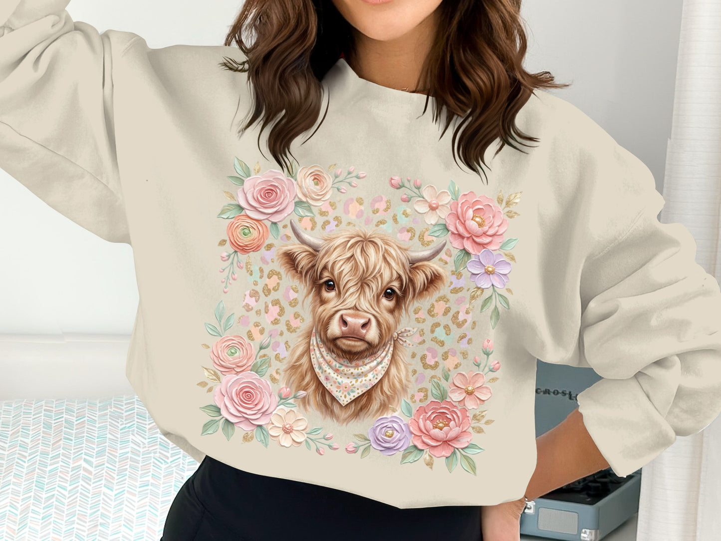 Cream sweatshirt with highland cow graphic and floral border.