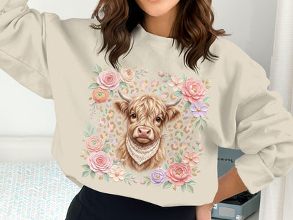 Cream sweatshirt with highland cow graphic and floral border.