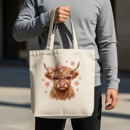 Tote bag with a cute highland cow wearing glasses and a pink bow.