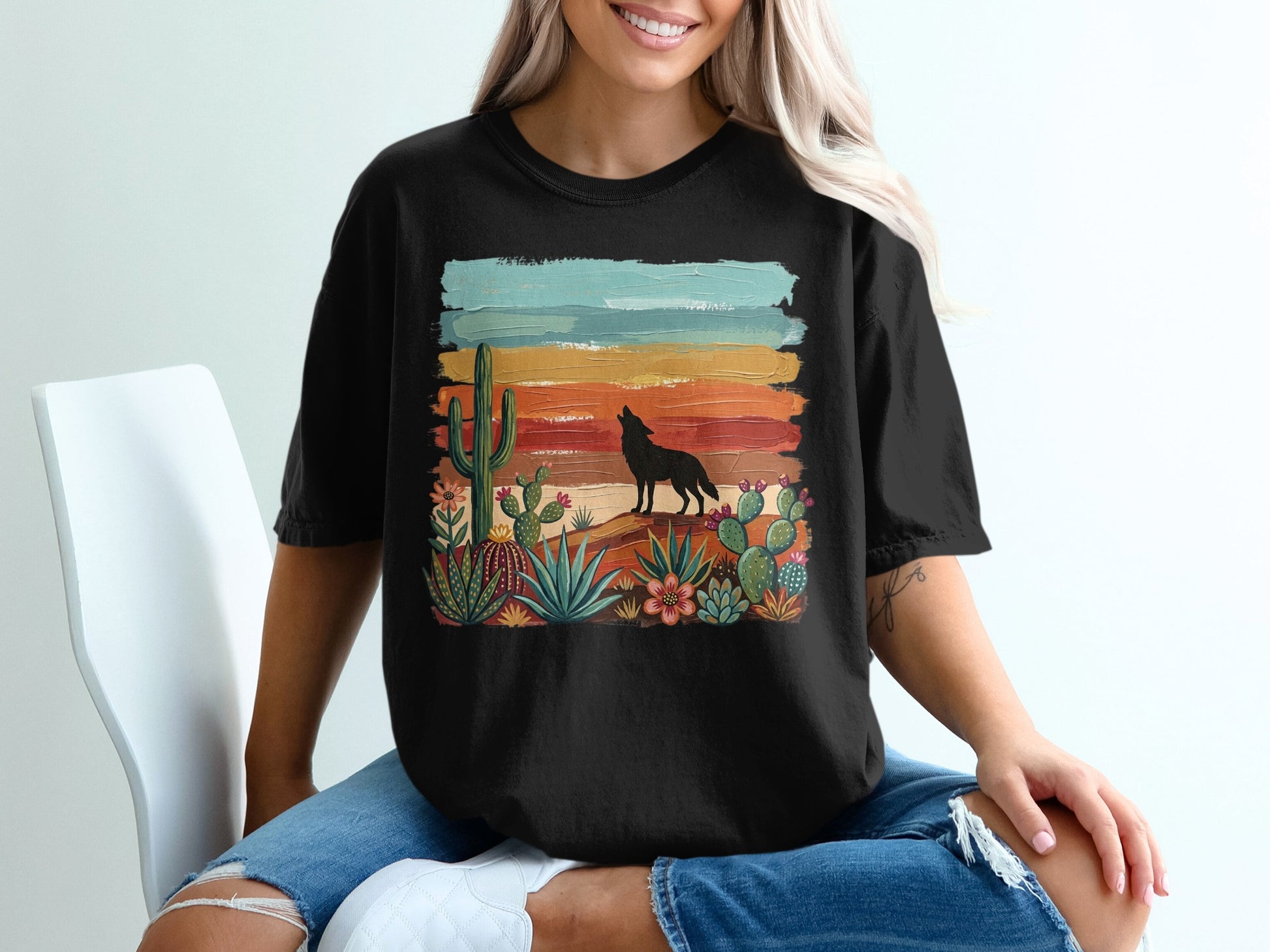 Black t-shirt with desert landscape graphic and howling wolf silhouette.
