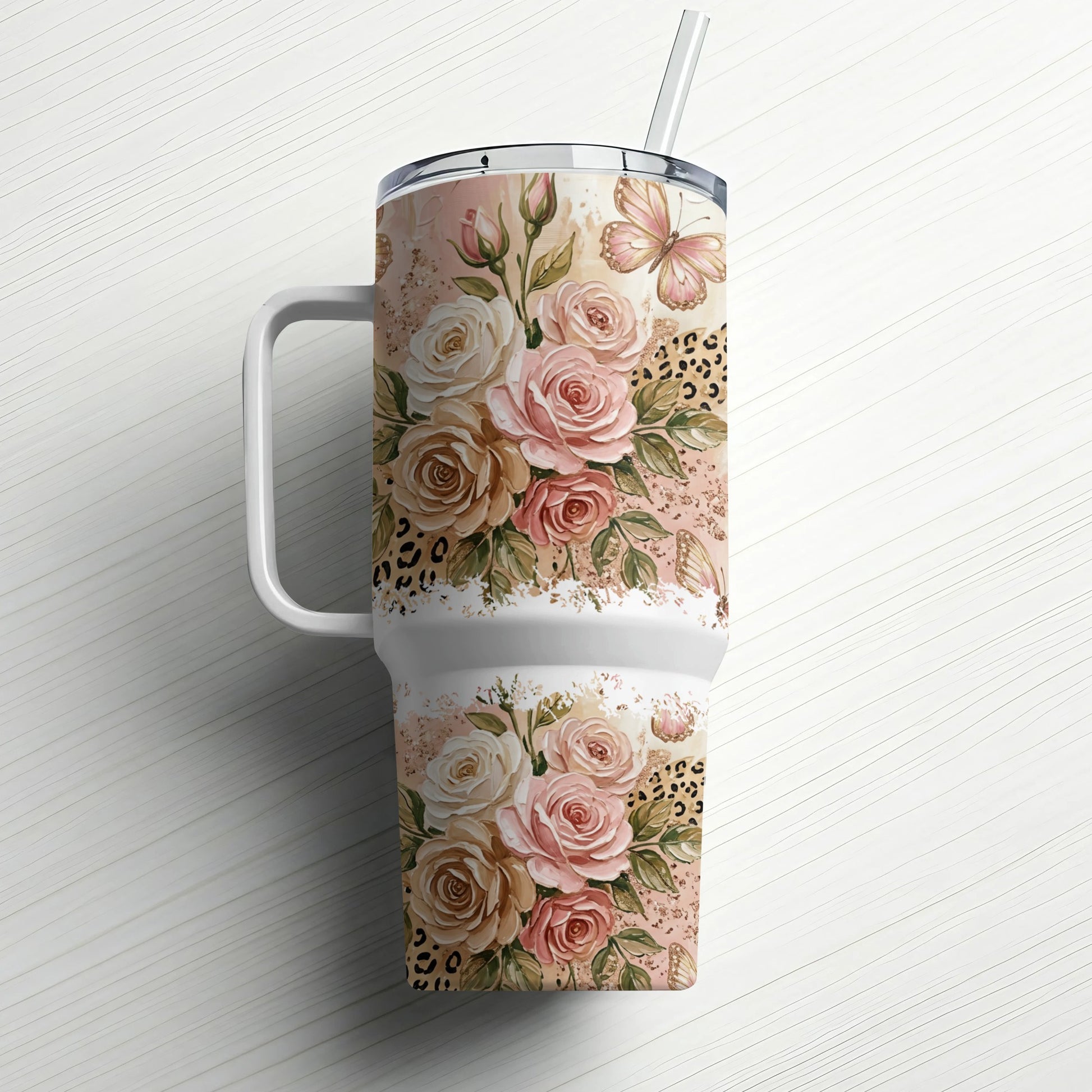 Floral and leopard print tumbler with handle and straw.