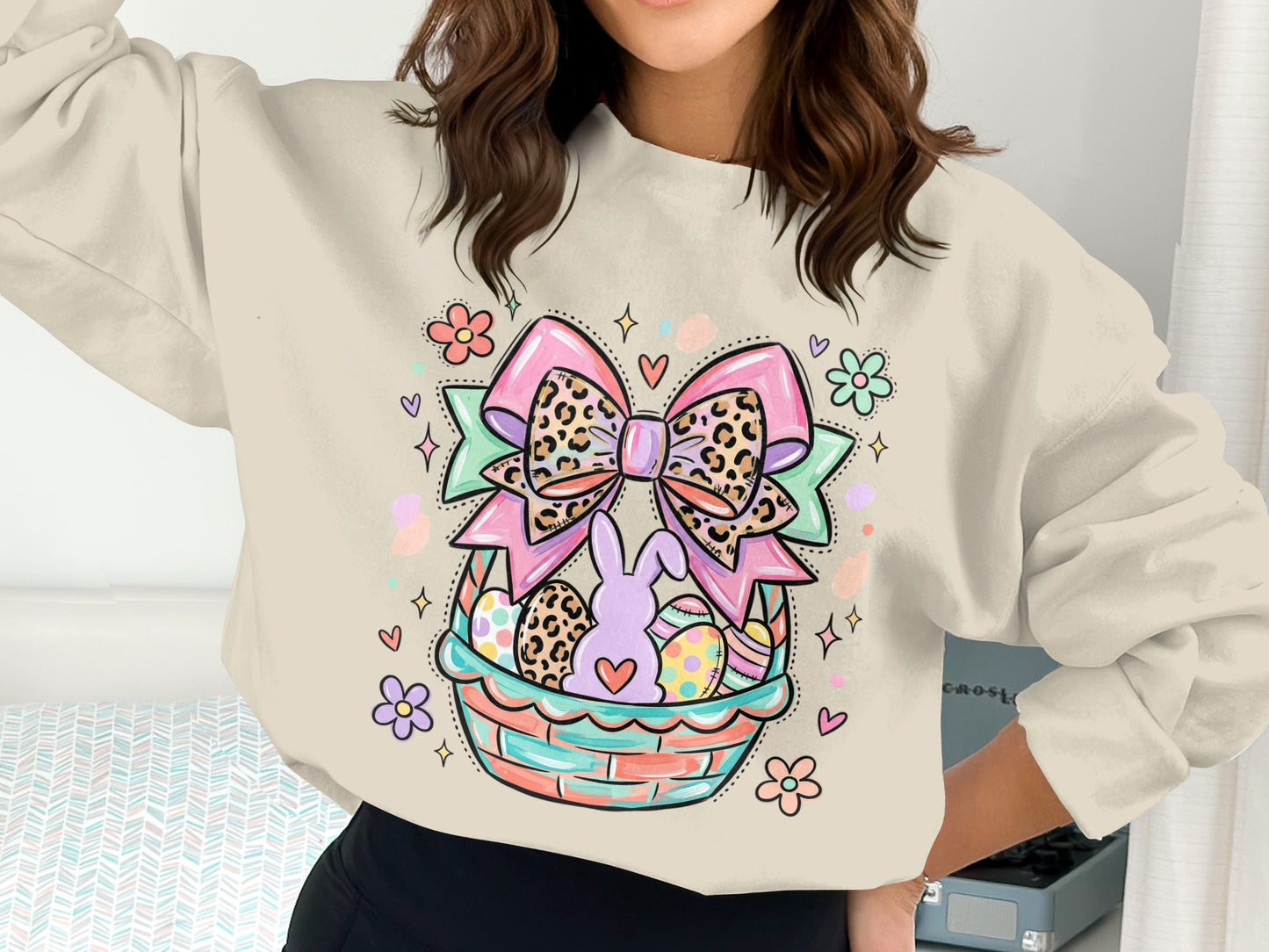 Cream sweatshirt with colorful Easter basket graphic featuring a leopard print bow and bunny.