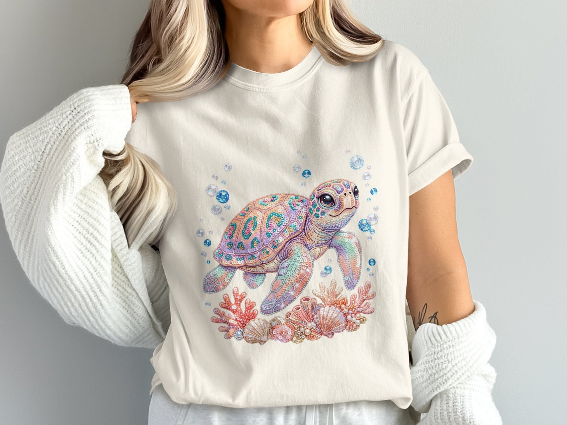 Graphic t-shirt featuring a watercolor sea turtle surrounded by coral and bubbles.
