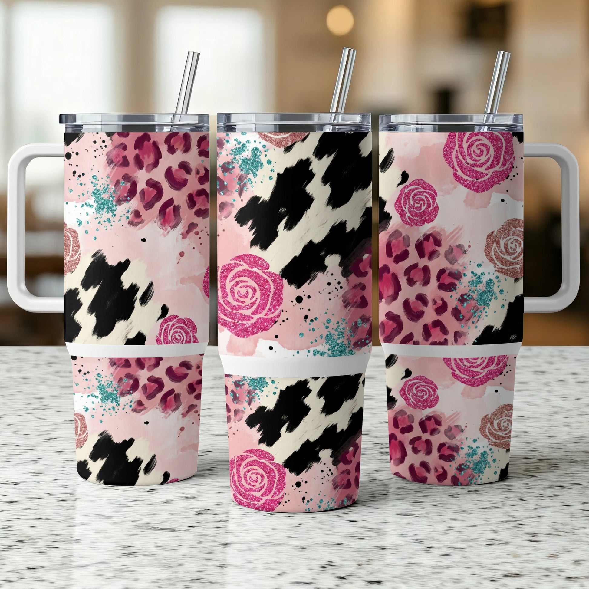 Three tumblers with pink roses, leopard print, and cow print designs.